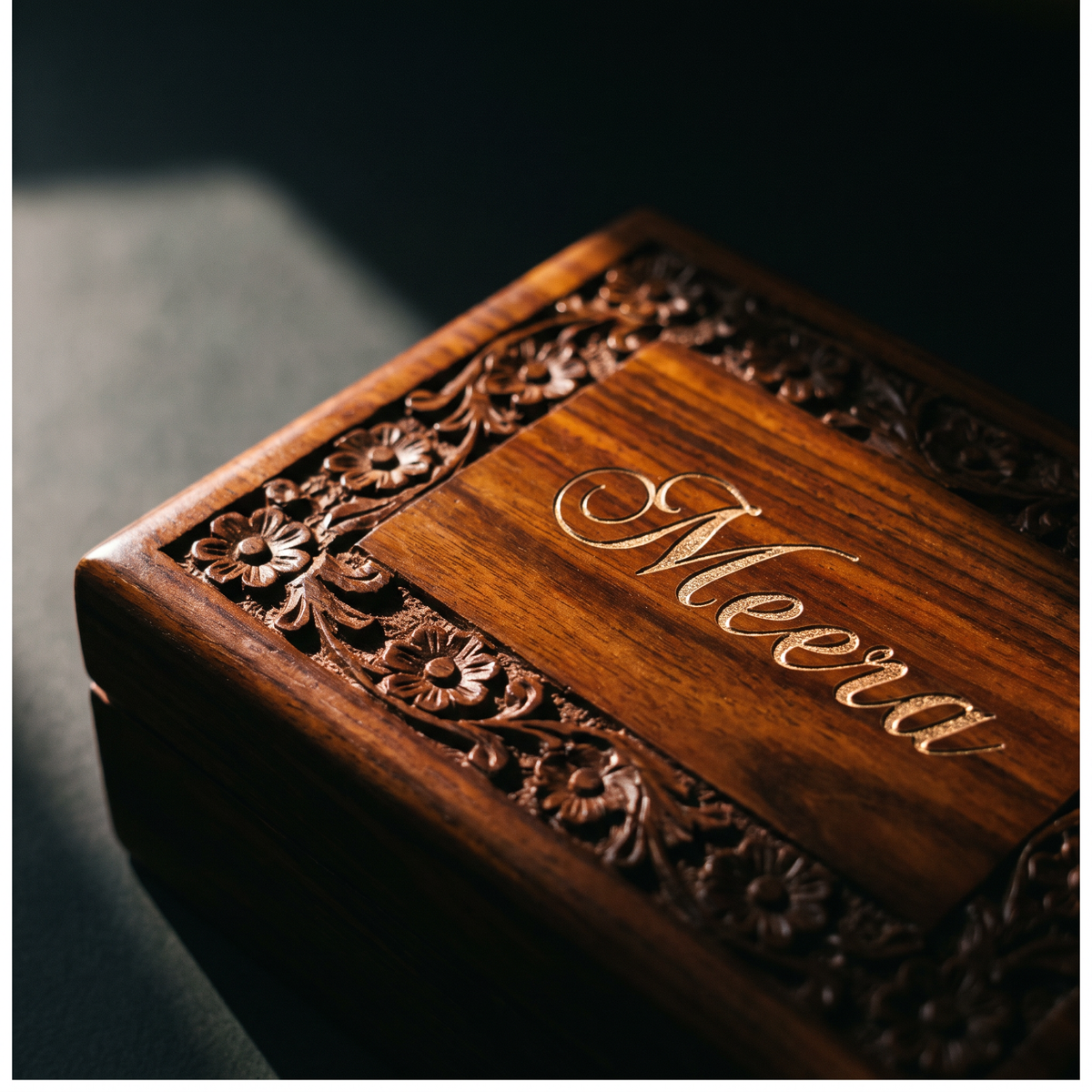 Close-up of engraved name on carved wooden lid