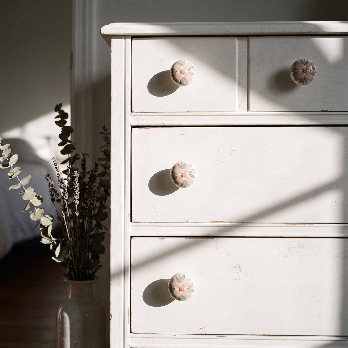 Pastel ceramic knobs on a white dresser